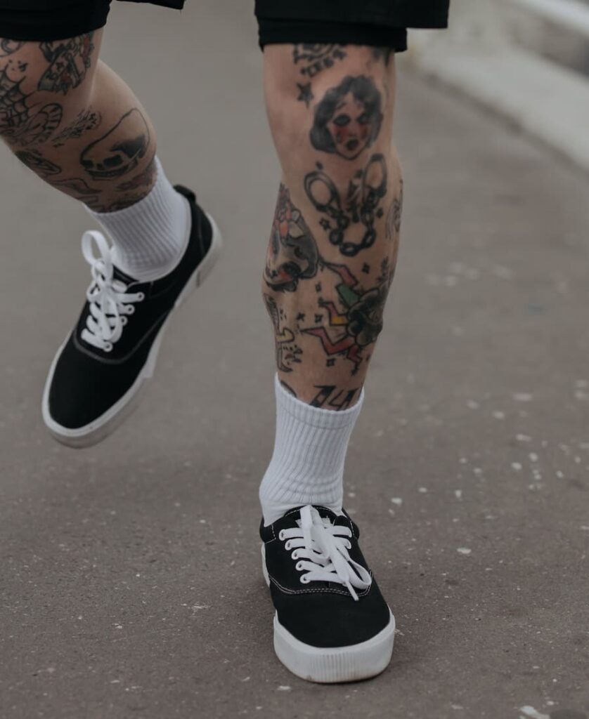 Man with tattoo walking down the street