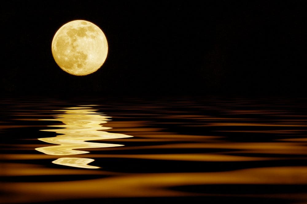 Yellow moon reflecting in the sea