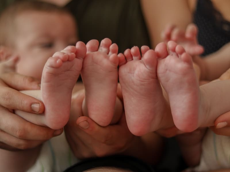 two babies showing their feet