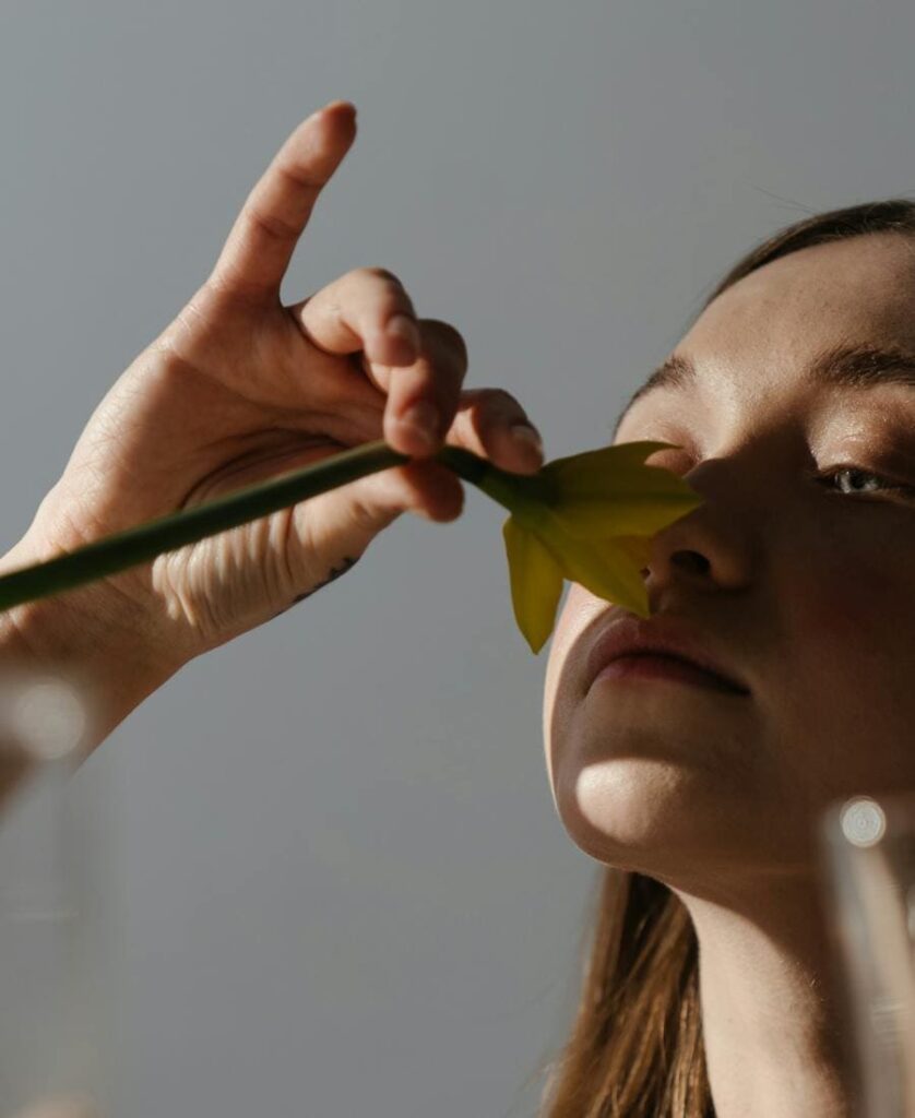Woman touching a leaf on her nose