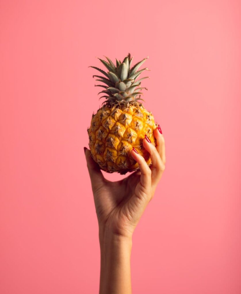 Someone holdin a pineapple